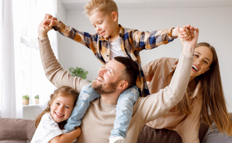 Young family playing on a couch