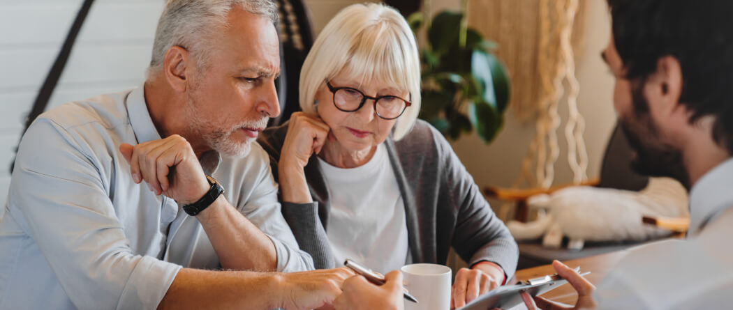 Older couple signing documents