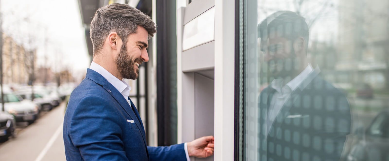 Man using an ATM outside